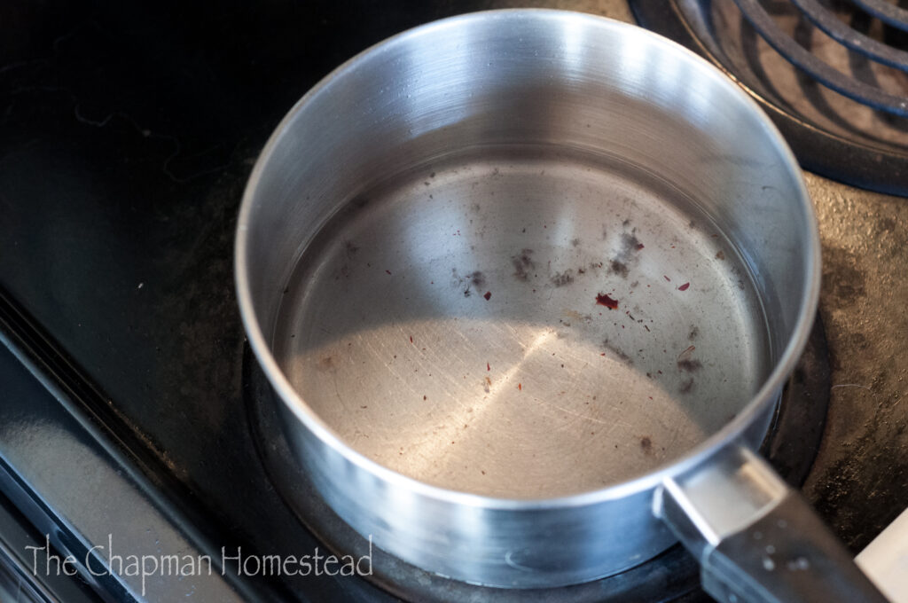 Photo of melted wax in the pot on the stove.