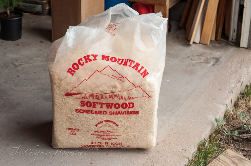 Bag of compressed pine shavings for use as bedding in brooder.