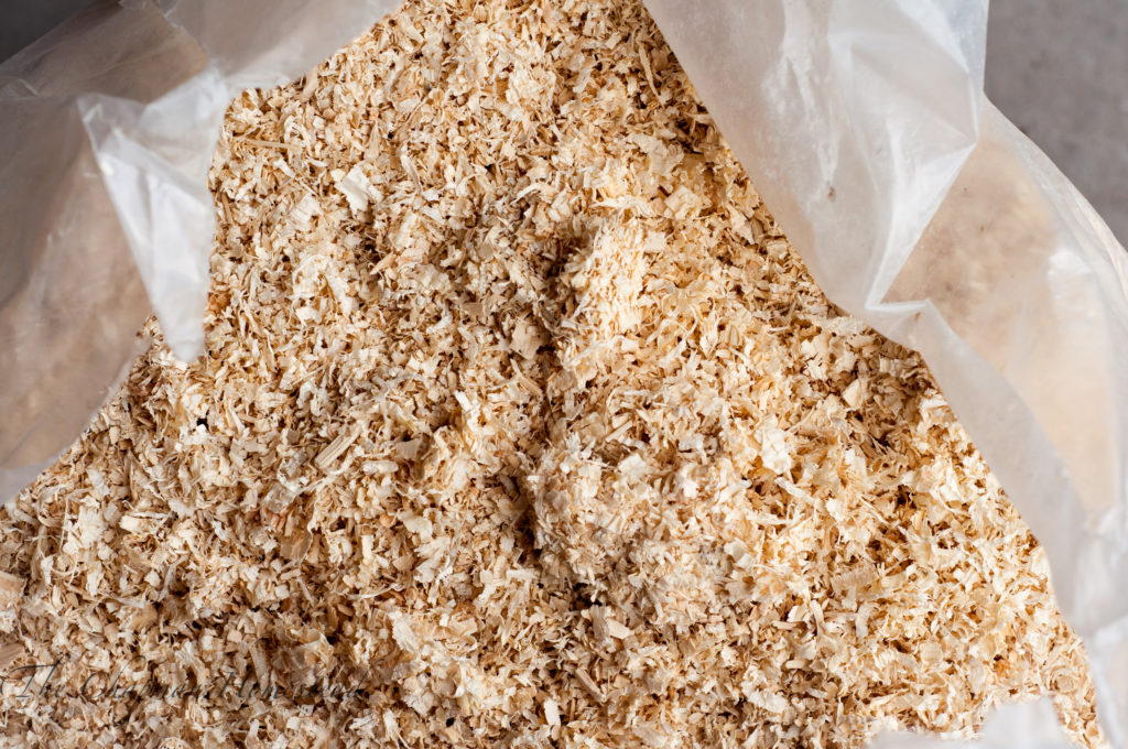 Open bag of pine shavings showing what fine pine shavings look like.