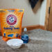 Photo of 12 pound bag of baking soda, small bottle of blue dawn dish soap, bowl with spoon in it.
